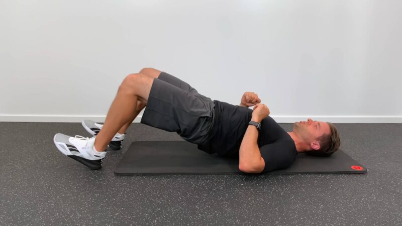The guy is doing exercises to strengthen his lower back