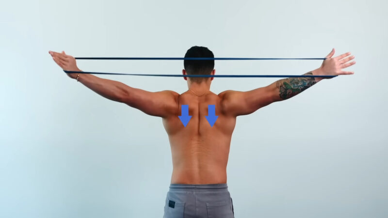Man streching his back with a resistance band for elevating back pain